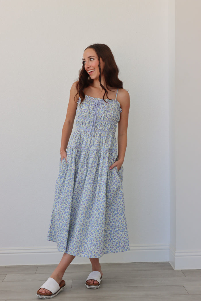 girl wearing light blue long floral dress