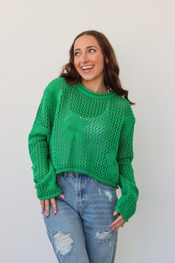 girl wearing bright green crochet long sleeve top