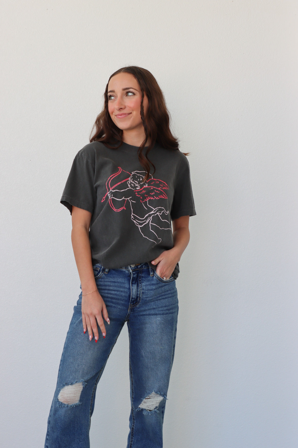 girl wearing black t-shirt with cupid graphic
