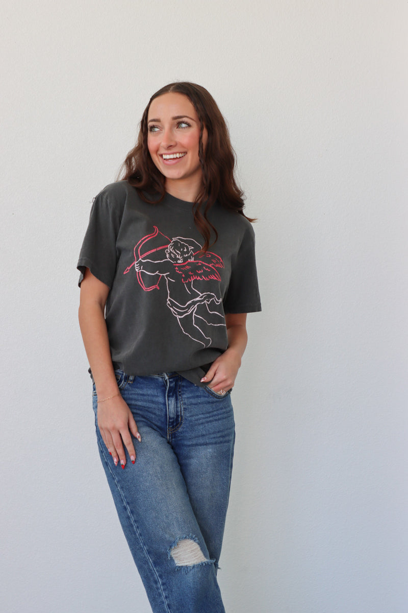 girl wearing black t-shirt with cupid graphic