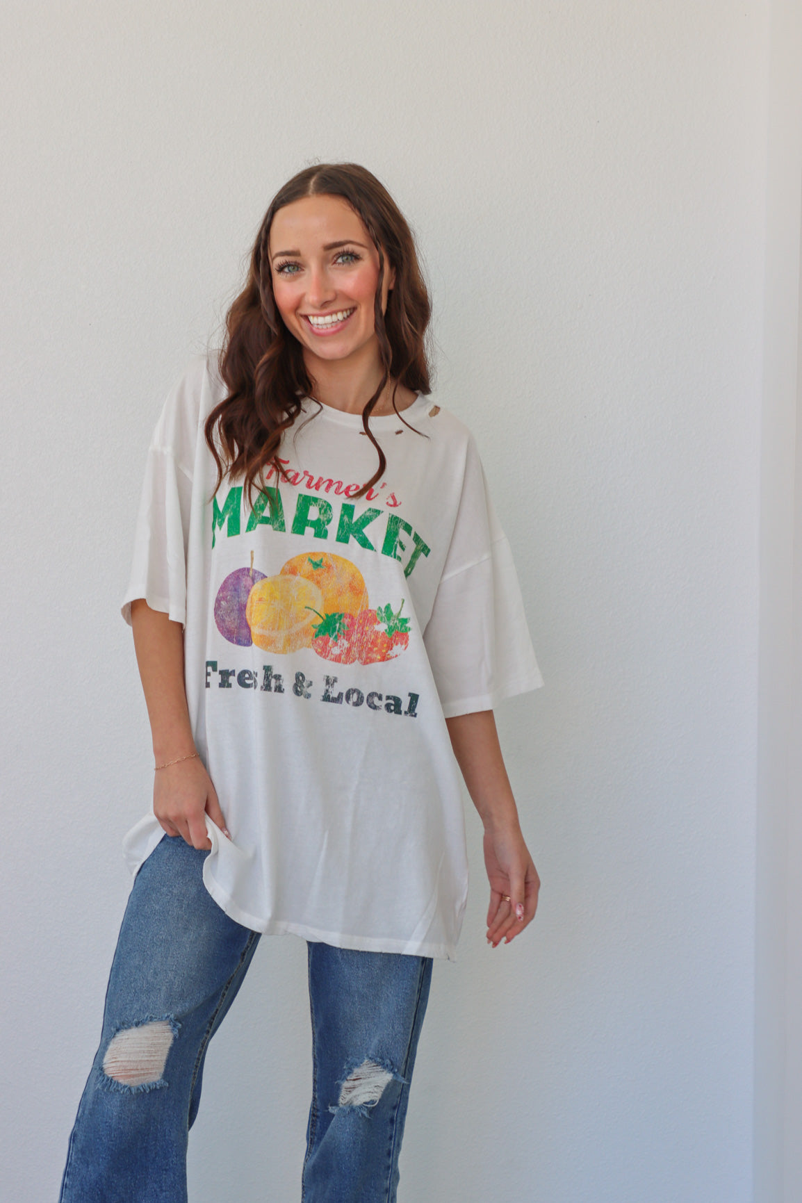girl wearing white farmer's market t-shirt