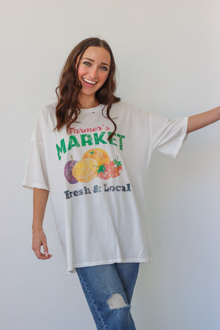 girl wearing white farmer's market t-shirt