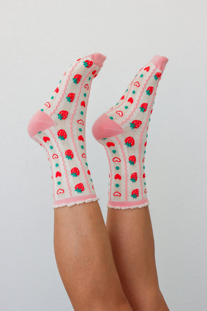 girl wearing pink strawberry socks