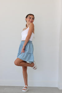 girl wearing light blue chambray skirt
