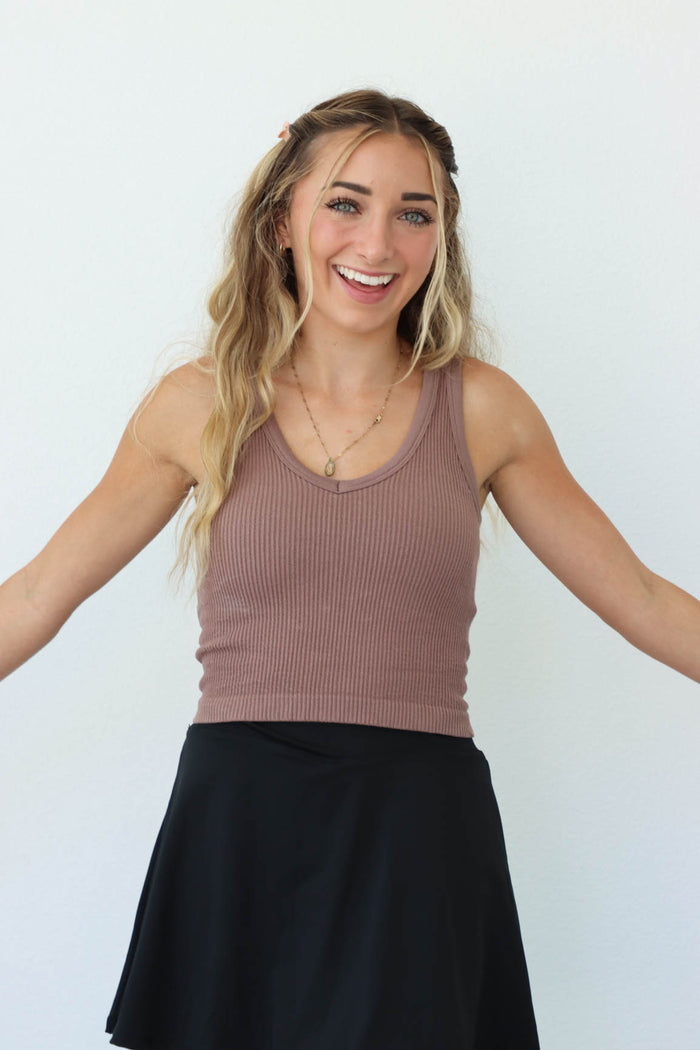 girl wearing light brown ribbed athletic tank