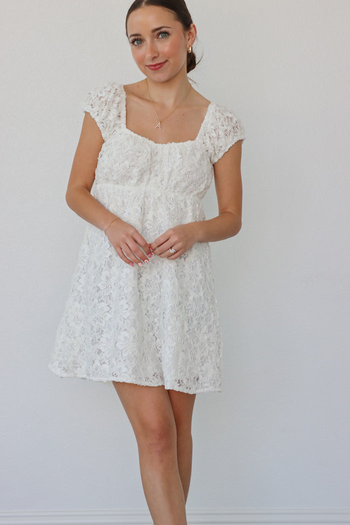 girl wearing white dress with floral fabric