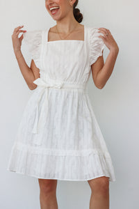 girl wearing white short sleeved dress