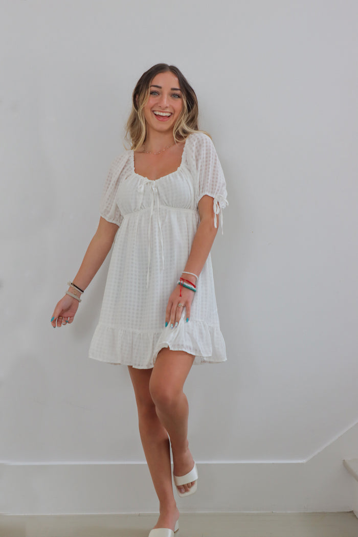 girl wearing short white dress