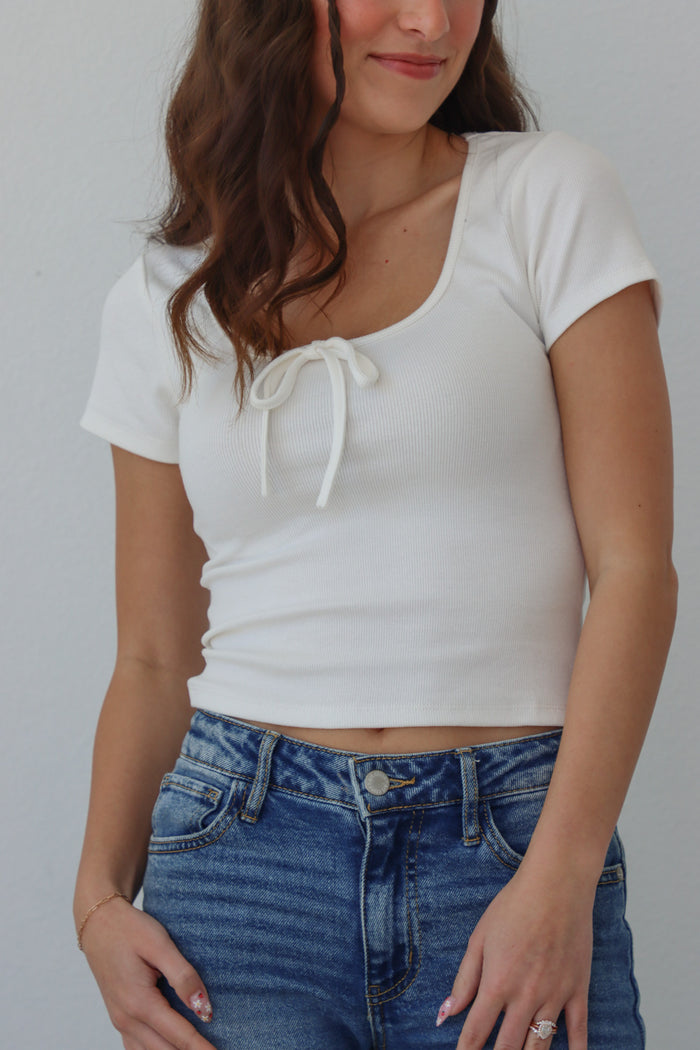 girl wearing white t-shirt with bow detail
