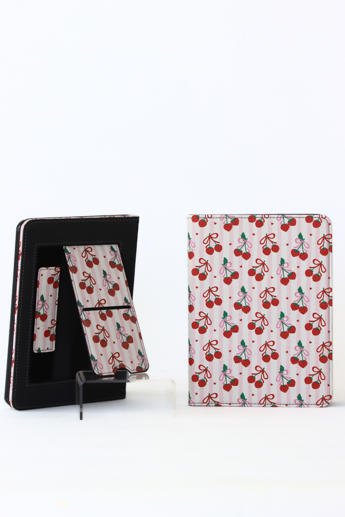 Cherry-patterned kindle case with stand feature on a white background