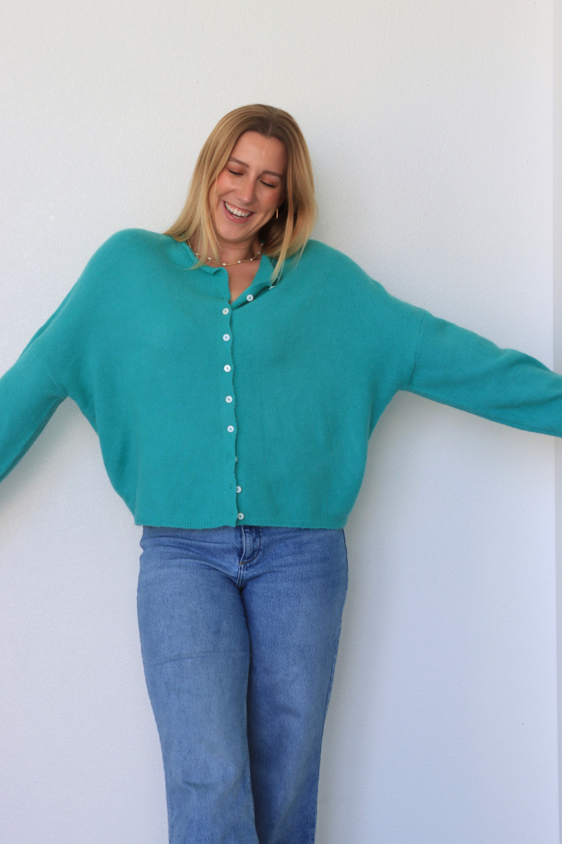 girl wearing teal cardigan