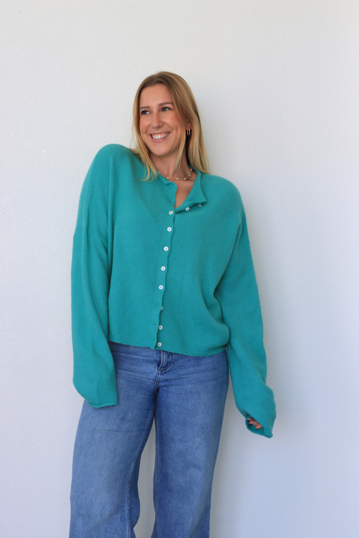 girl wearing teal cardigan