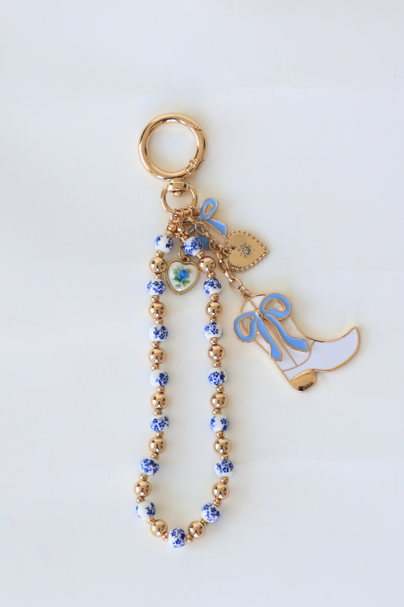 Keychain with decorative elements on a light gray background