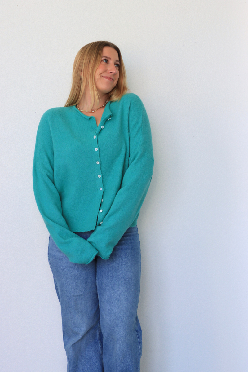 girl wearing teal cardigan
