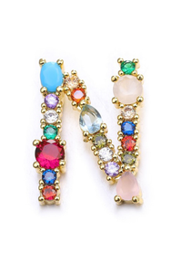Multicolored gemstone earrings on a white background