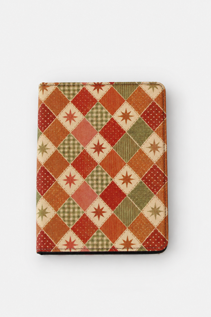 A rectangular tablet case featuring a vintage-style patchwork argyle pattern with red, orange, green, and beige diamond sections, set against a plain light gray background.