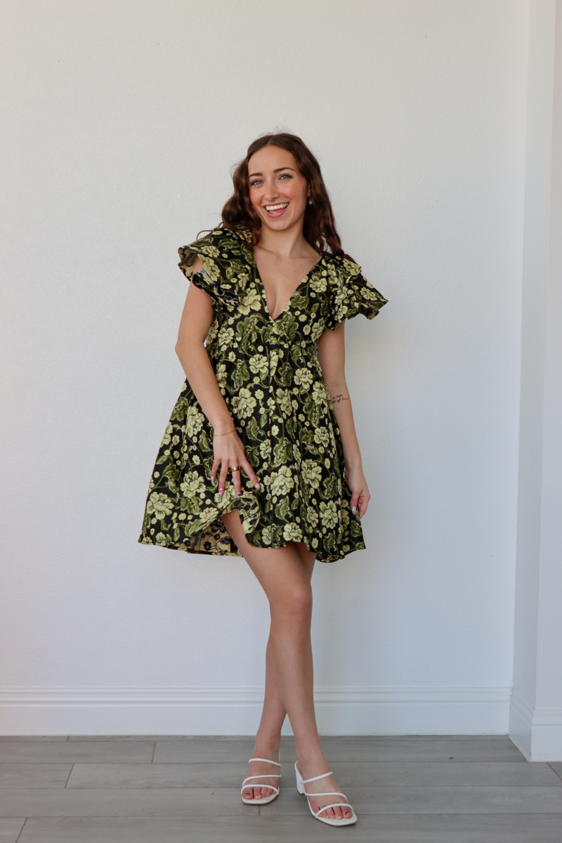 girl wearing black and green floral babydoll dress