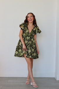 girl wearing black and green floral babydoll dress