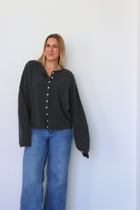 girl wearing dark gray cardigan