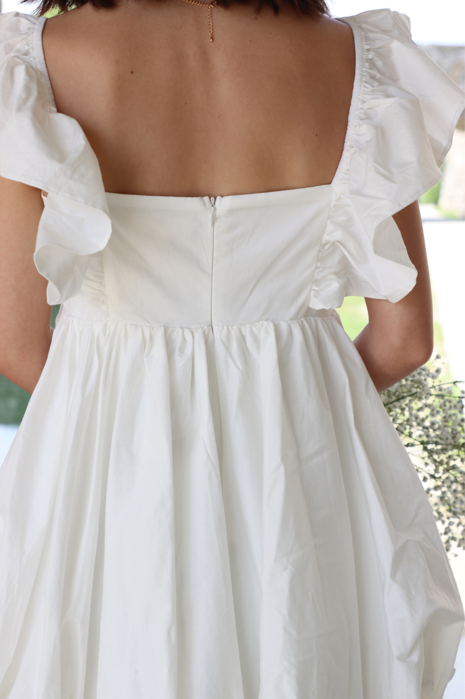 back of short white bubble dress