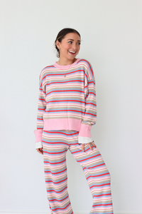 Woman wearing a colorful striped set against a white background