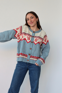 girl wearing light blue knit cardigan