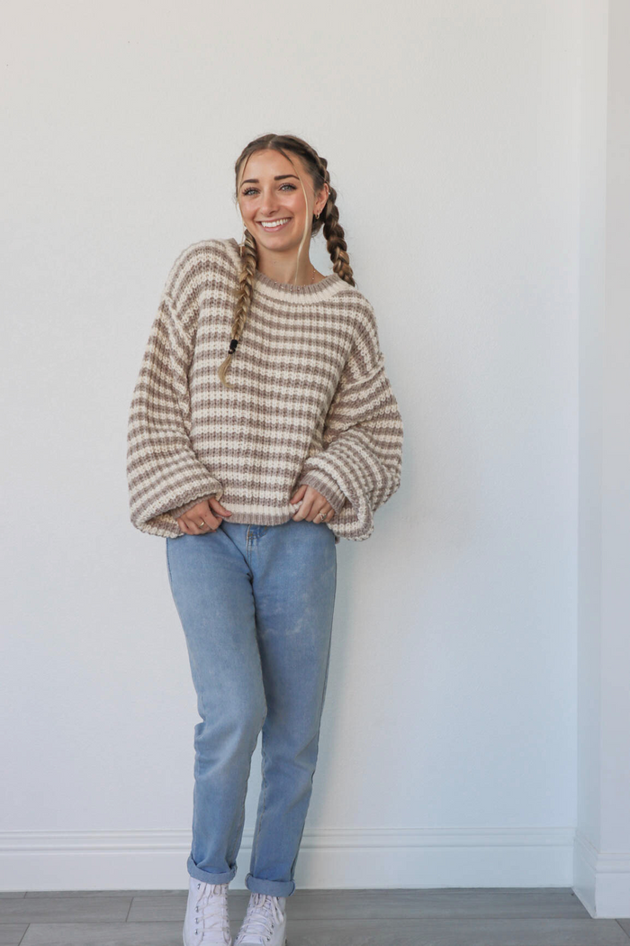 girl wearing tan & cream striped knit sweater