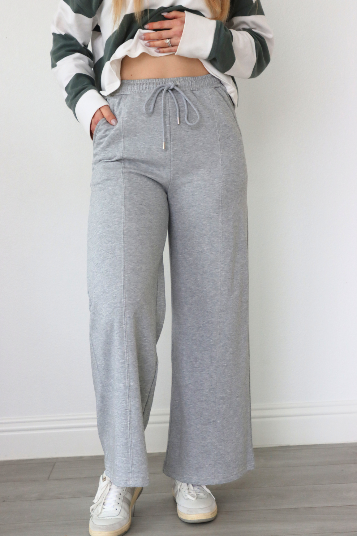 girl wearing gray sweatpants with bow pocket detailing