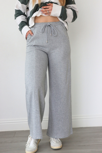 girl wearing gray sweatpants with bow pocket detailing