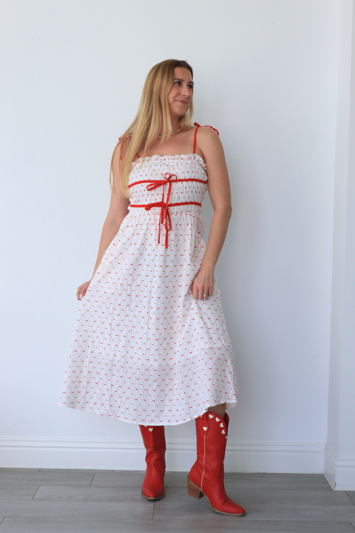 girl wearing white dress with red heart detailing