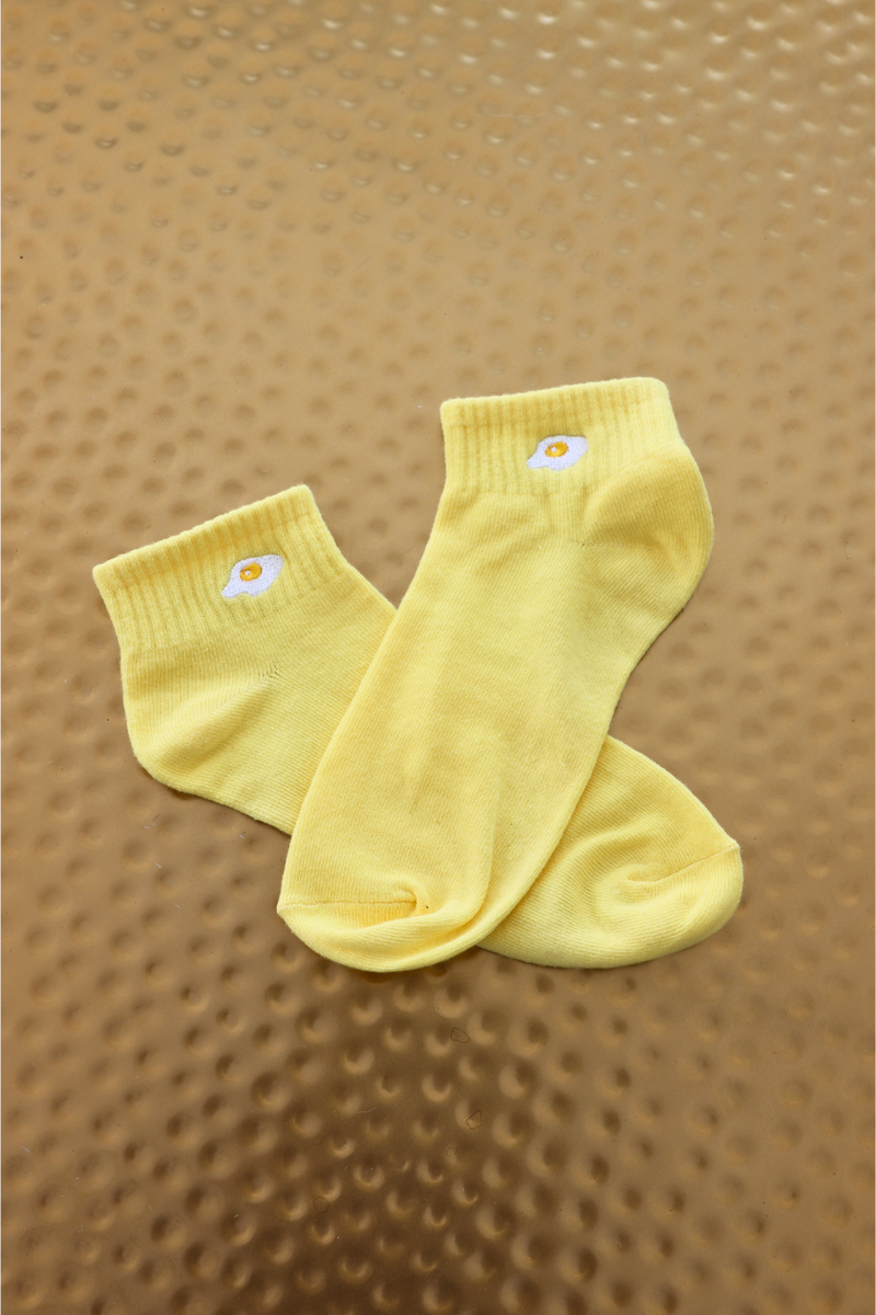 yellow socks with embroidered egg graphic