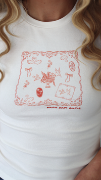Woman wearing a white t-shirt with a graphic design saying amour amour amour 