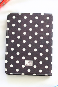 Polka dot kindle cover with visible brand logo on a white background