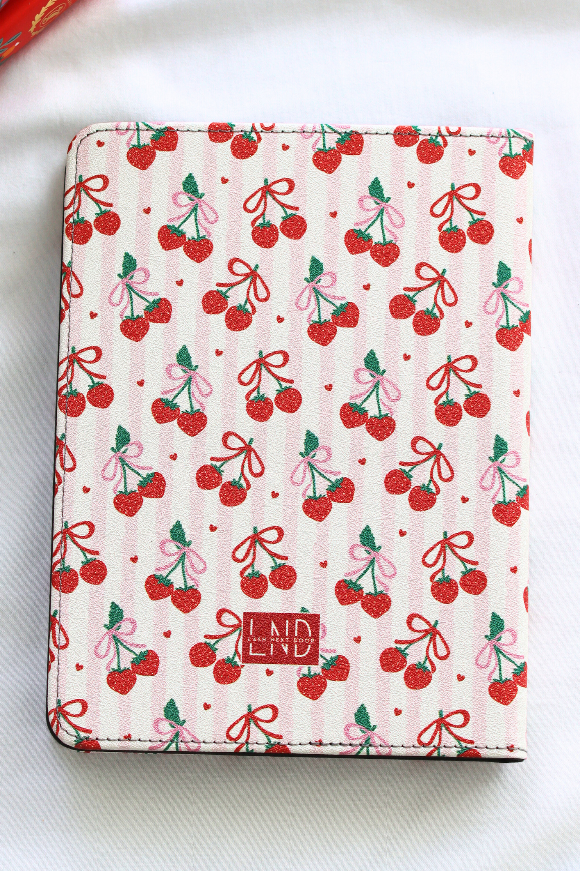 kindle cover with cherry and bow pattern on a white background