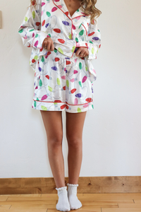 Person wearing a colorful pajama set with a white background
