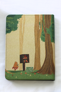 Kindle cover with forest design featuring trees, flowers, and a signpost on a white background
