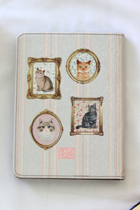 Kindle Case with cat-themed cover featuring framed illustrations of cats on a striped background 