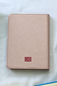 Pink kindle with a red logo on a white background