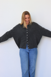 girl wearing dark gray cardigan