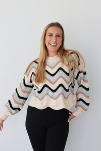 Woman wearing a striped sweater against a white background