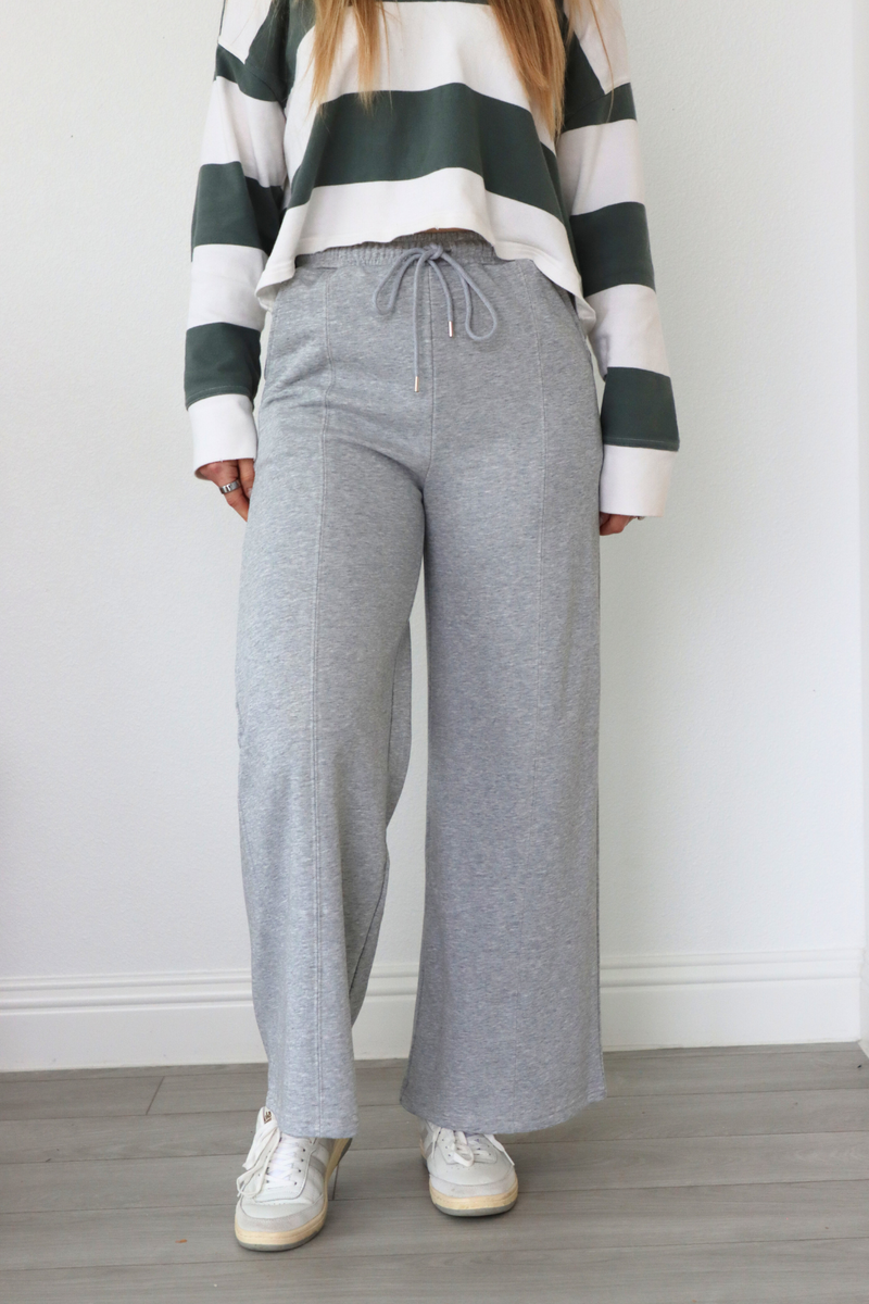 girl wearing gray sweatpants with bow pocket detailing