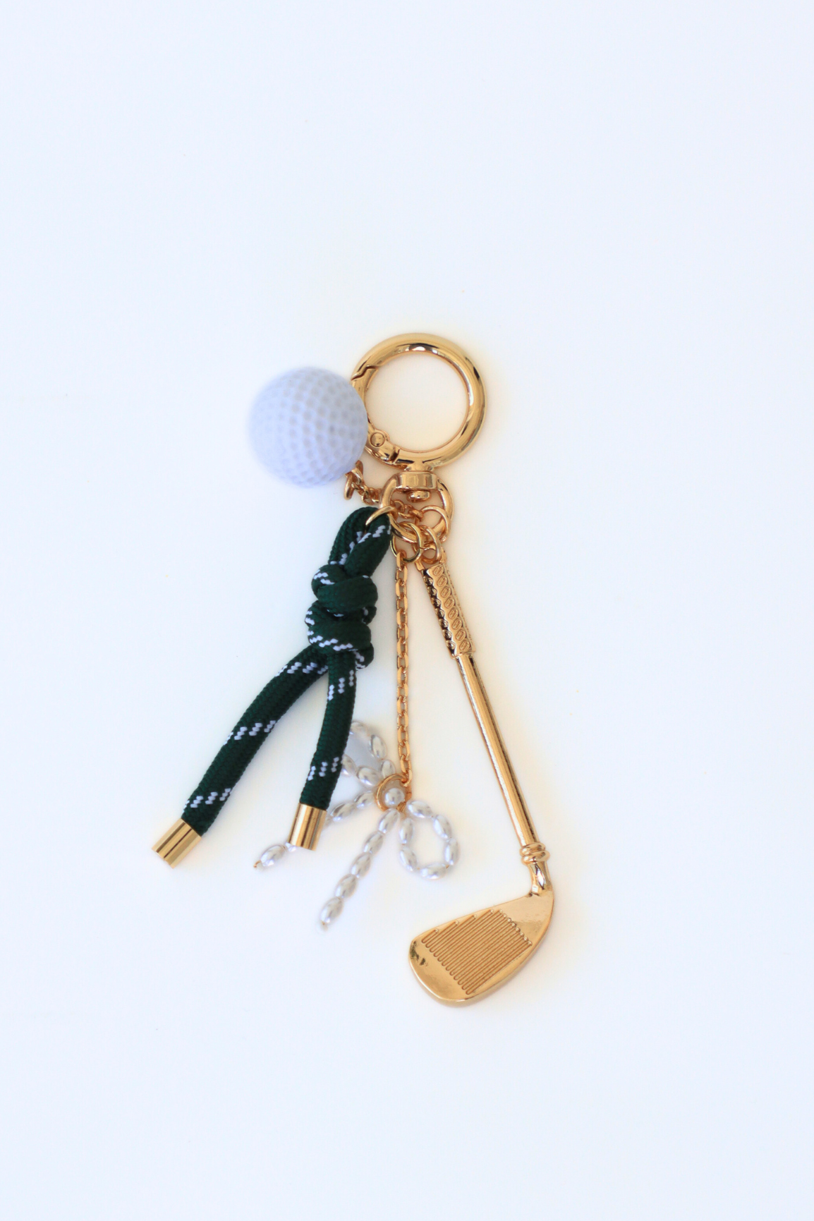Keychain with golf-themed charms on a white background