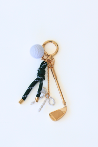 Keychain with golf-themed charms on a white background