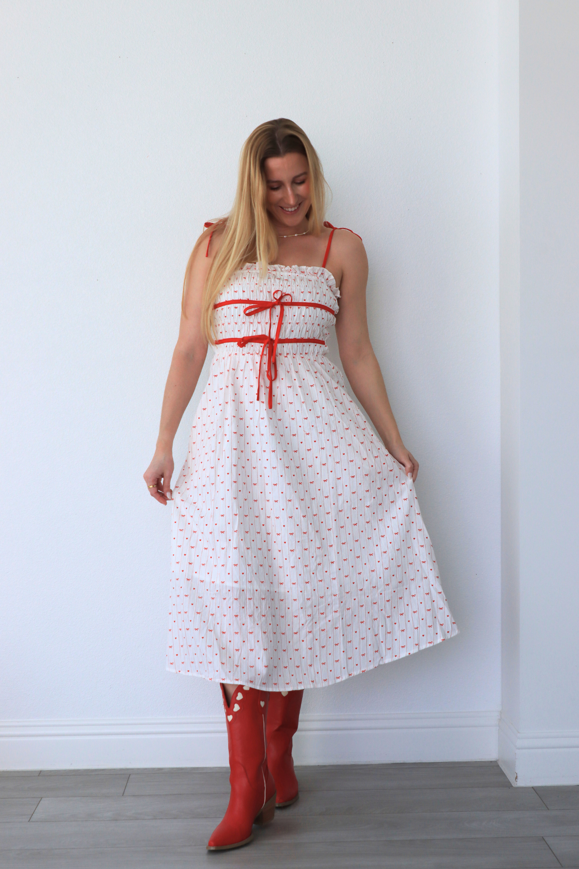 girl wearing white dress with red heart detailing