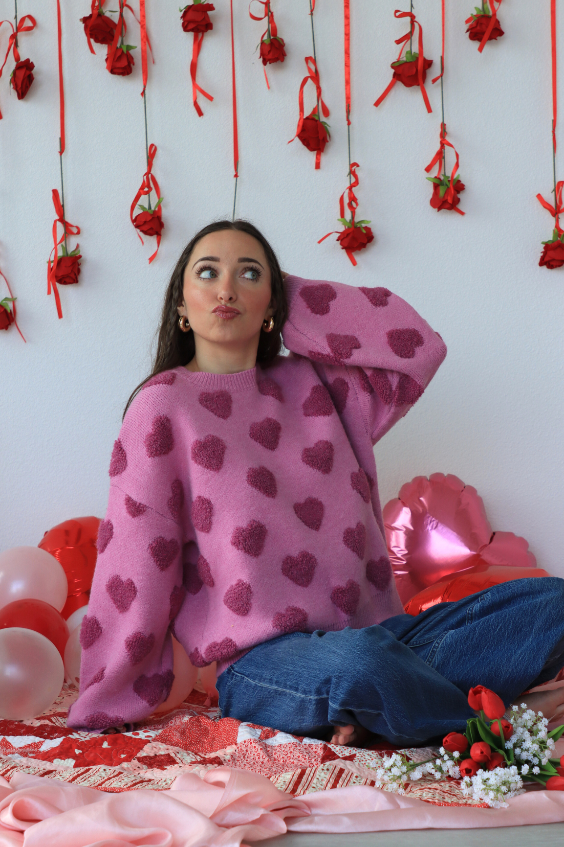 girl wearing pink heart sweater