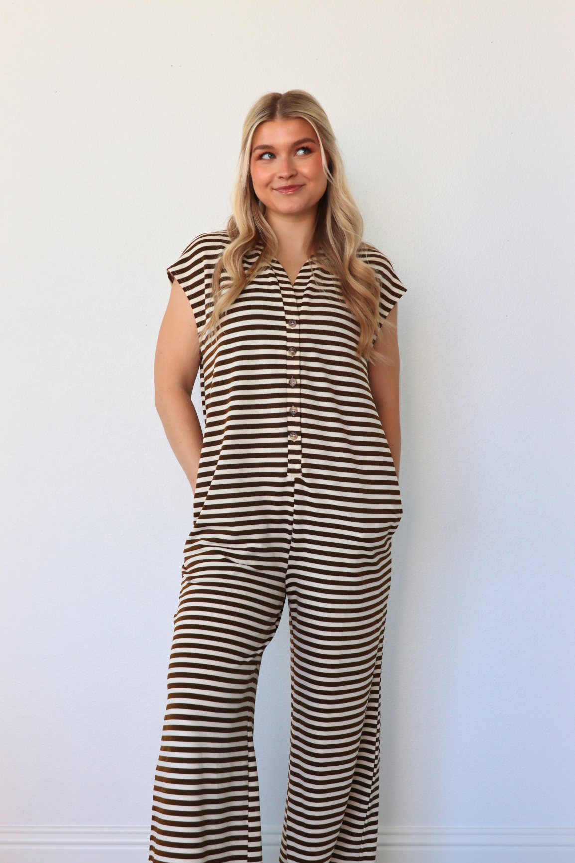 girl wearing brown and cream striped jumpsuit