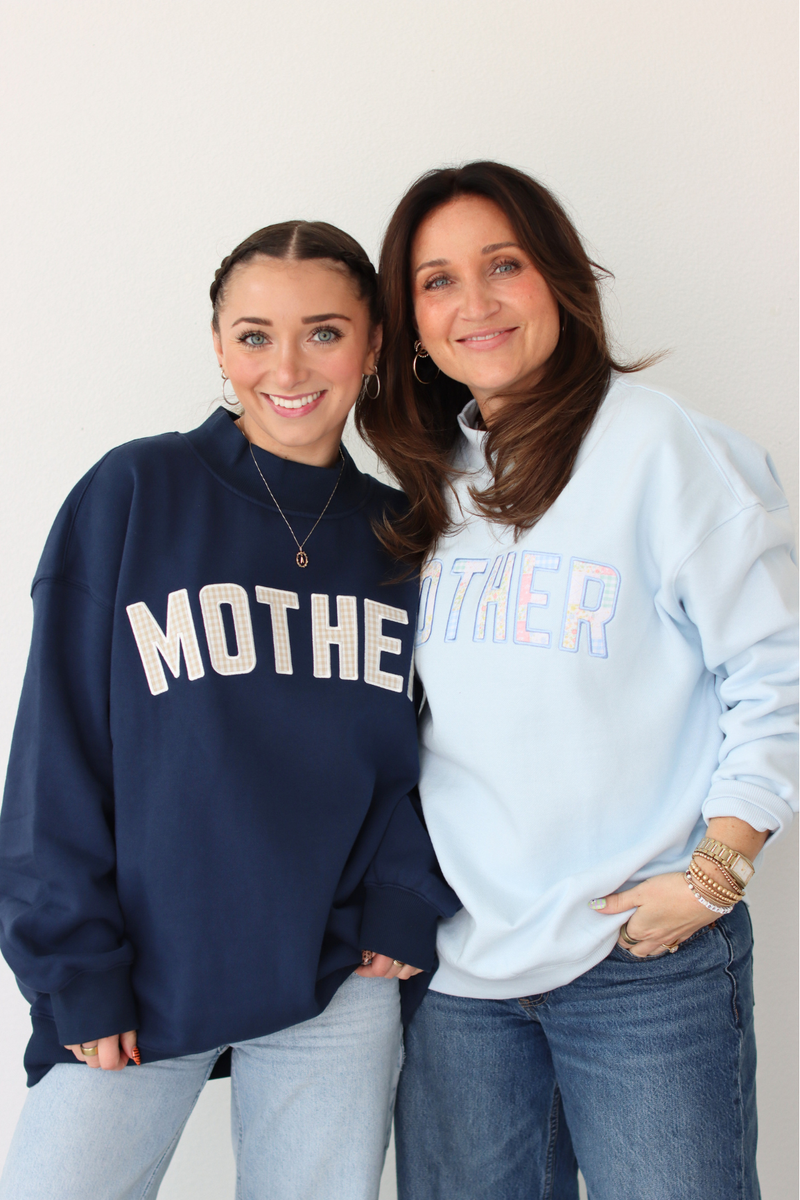Two women wearing MOTHER sweatshirts