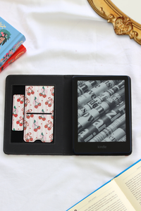 Open kindle with cherry design on a white surface.