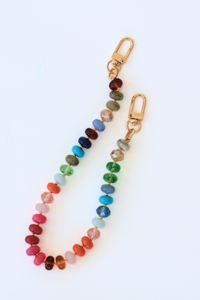 Multicolored beaded keychain with gold clasp on a white background