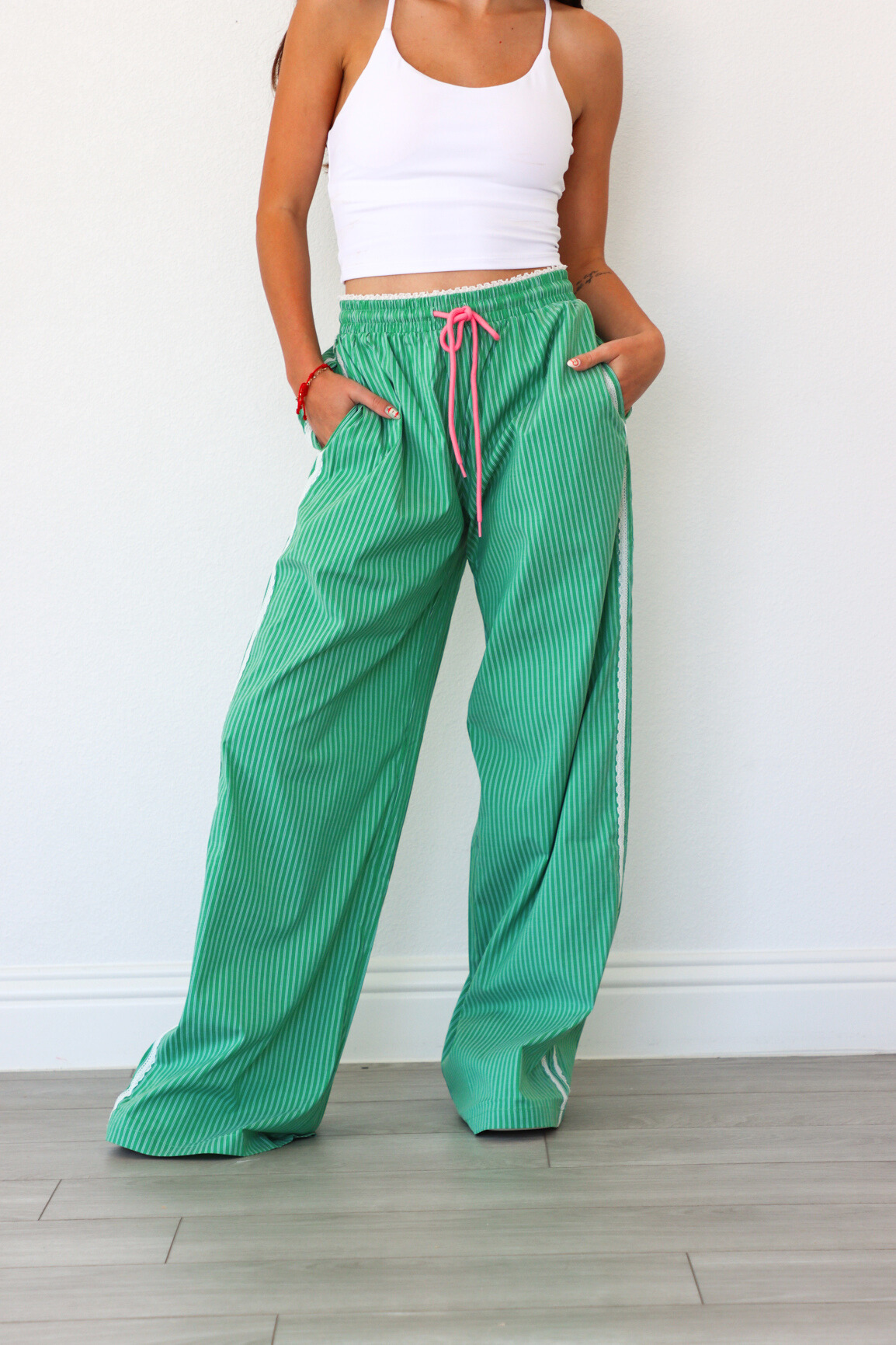 Person wearing green checkered pants with a white background